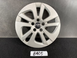 Silver Toyota alloy wheel with an eight-spoke design and a central Toyota emblem, sits on a dark surface with a B405 label in front.
