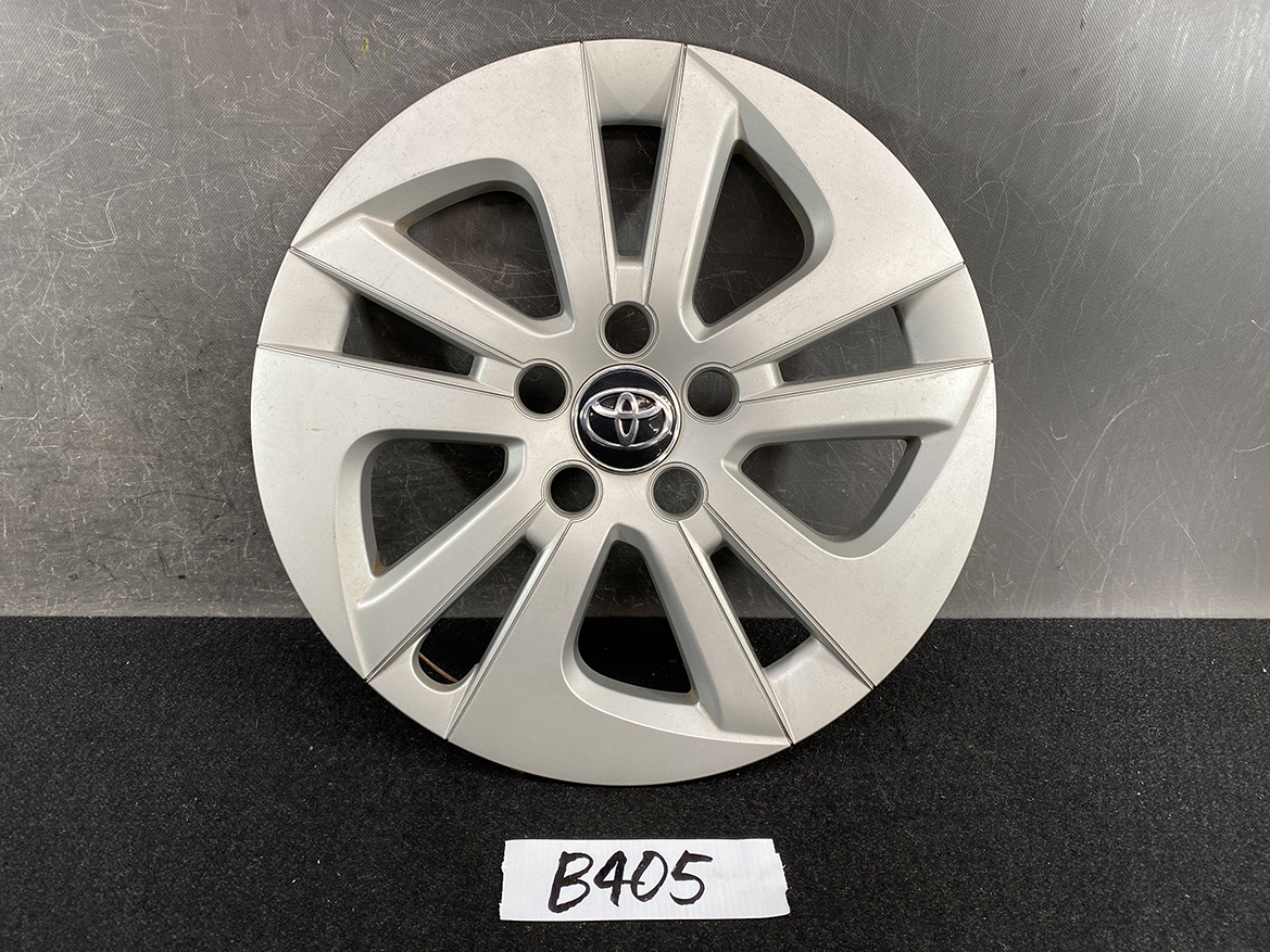 B405_1 TOYOTA PRIUS ZVW50 ZVW51 Genuine 15inch WHEEL CAP / HUB CAP » NZ.95 » JDM-PARTS NZ » JDM-PARTS NZ Silver Toyota alloy wheel with an eight-spoke design and a central Toyota emblem, sits on a dark surface with a B405 label in front. TOYOTA PRIUS ZVW50 ZVW51 Genuine 15inch WHEEL CAP / HUB CAP » JDM-PARTS NZ