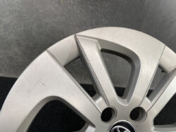 Close-up of a silver alloy car wheel with five spokes and a Volkswagen center cap.