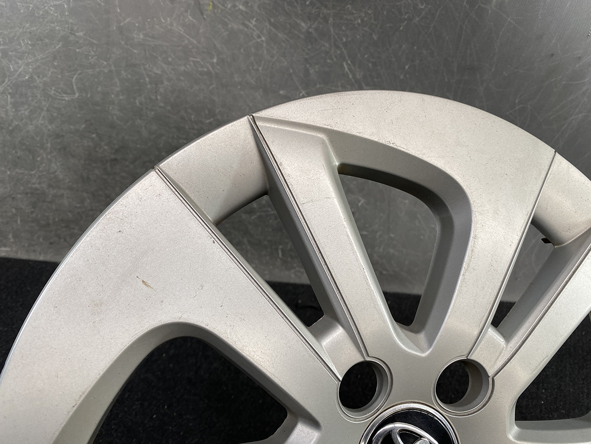 B405_4 TOYOTA PRIUS ZVW50 ZVW51 Genuine 15inch WHEEL CAP / HUB CAP » NZ.95 » JDM-PARTS NZ » JDM-PARTS NZ Close-up of a silver alloy car wheel with five spokes and a Volkswagen center cap. TOYOTA PRIUS ZVW50 ZVW51 Genuine 15inch WHEEL CAP / HUB CAP » JDM-PARTS NZ