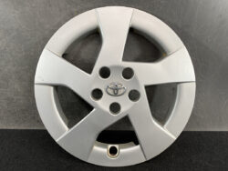 Silver Toyota hubcap with five spokes and central emblem