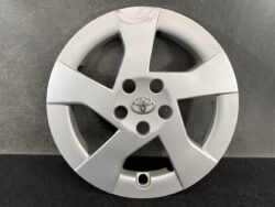 Five-spoke silver Toyota alloy wheel cover with a central emblem and five lug holes around the hub.