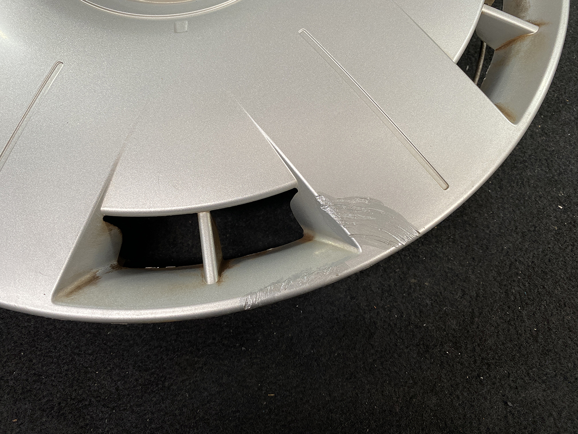 B413_6 TOYOTA VOXY ZWR80 Genuine 15inch WHEEL CAP / HUB CAP 2595 x1 » NZ.95 » JDM-PARTS NZ » JDM-PARTS NZ Close-up of a silver alloy wheel with a chipped edge and rust stains along the rim around a damaged section TOYOTA VOXY ZWR80 Genuine 15inch WHEEL CAP / HUB CAP 2595 x1 » JDM-PARTS NZ