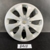 Silver Toyota hubcap with a central Toyota emblem, resting on a dark surface. TOYOTA PRIUS C AQUA NHP10 Genuine 15inch WHEEL CAP / HUB CAP 42602-52540 x1 » JDM-PARTS NZ