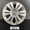 Silver Nissan hubcap with 12 spokes and a central Nissan emblem on a dark surface. TOYOTA PRIUS C AQUA NHP10 Genuine 15inch WHEEL CAP / HUB CAP 42602-52540 x1 » JDM-PARTS NZ