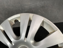 Close-up of a silver car wheel rim with surface scratches along the outer edge and darkened wear marks.