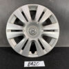 Front view of a silver Nissan hubcap with multiple angled spokes and a central Nissan emblem, placed on a dark surface with a handwritten 'B420' label beneath. NISSAN Genuine 15inch WHEEL CAP / HUB CAP 40315-1GK0A x1 » JDM-PARTS NZ