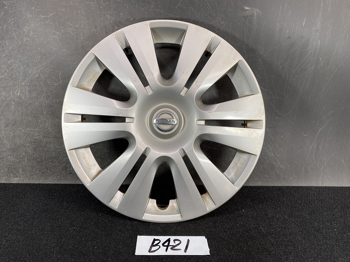 B421_1 NISSAN Genuine 15inch WHEEL CAP / HUB CAP 40315-1GK0A x1 » NZ.95 » JDM-PARTS NZ » JDM-PARTS NZ Silver Nissan hubcap with multiple spokes resting on a dark surface; center features Nissan logo in a circular badge (wheel cover) NISSAN Genuine 15inch WHEEL CAP / HUB CAP 40315-1GK0A x1 » JDM-PARTS NZ