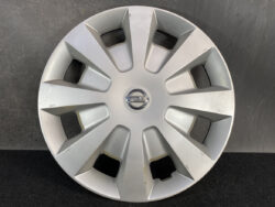 Silver Nissan hubcap with a multi-spoke design and the Nissan emblem at the center.