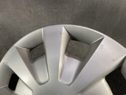 Close-up of a silver alloy wheel rim with scratches and scuffs.
