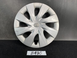Silver Toyota hubcap with a radial eight-spoke design and center emblem on a dark surface. TOYOTA PORTE / SPADE Genuine 15inch WHEEL CAP / HUB CAP 42602-52450 x1 » JDM-PARTS NZ