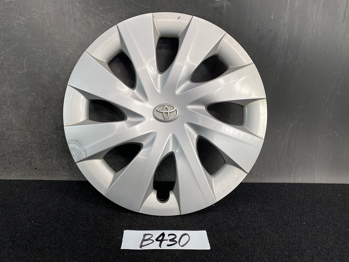 B430_1 TOYOTA PORTE / SPADE Genuine 15inch WHEEL CAP / HUB CAP 42602-52450 x1 » NZ.95 » JDM-PARTS NZ » JDM-PARTS NZ Silver Toyota hubcap with a radial eight-spoke design and center emblem on a dark surface. TOYOTA PORTE / SPADE Genuine 15inch WHEEL CAP / HUB CAP 42602-52450 x1 » JDM-PARTS NZ