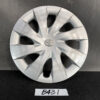 B431_1 TOYOTA PORTE / SPADE Genuine 15inch WHEEL CAP / HUB CAP 42602-52450 x1 » NZ.95 » JDM-PARTS NZ » JDM-PARTS NZ Silver Toyota hubcap with a 10-spoke design, resting on a dark surface; visible scuffs and scratches on the face of the wheel cover. TOYOTA PORTE / SPADE Genuine 15inch WHEEL CAP / HUB CAP 42602-52450 x1 » JDM-PARTS NZ
