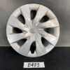 B433_1 TOYOTA PRIUS NHW20 Genuine 15inch WHEEL CAP / HUB CAP x1 » NZ.95 » JDM-PARTS NZ » JDM-PARTS NZ Silver Toyota hubcap with a central logo and several scratches on the right side, resting on a dark surface. TOYOTA PRIUS NHW20 Genuine 15inch WHEEL CAP / HUB CAP x1 » JDM-PARTS NZ