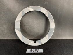 Gray circular ring with faceted outer edge and a small notch at the bottom, placed on a dark surface. TOYOTA PRIUS NHW20 Genuine 15inch WHEEL CAP / HUB CAP x1 » JDM-PARTS NZ