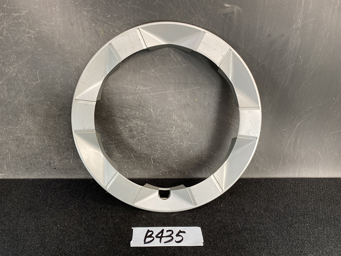 B435_1 TOYOTA PRIUS NHW20 Genuine 15inch WHEEL CAP / HUB CAP x1 » NZ.95 » JDM-PARTS NZ » JDM-PARTS NZ Light gray circular plastic ring with eight beveled segments around the edge, open center, on a dark table; labeled B435. TOYOTA PRIUS NHW20 Genuine 15inch WHEEL CAP / HUB CAP x1 » JDM-PARTS NZ