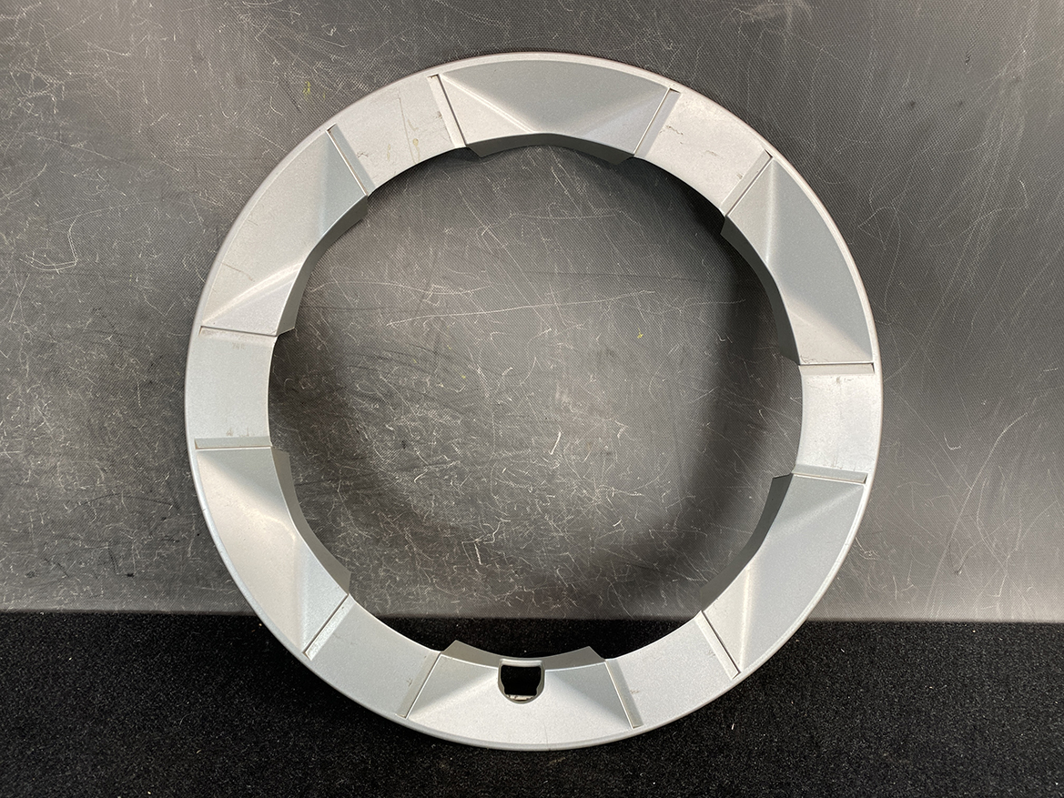 B435_2 TOYOTA PRIUS NHW20 Genuine 15inch WHEEL CAP / HUB CAP x1 » NZ.95 » JDM-PARTS NZ » JDM-PARTS NZ Gray circular ring with segmented outer edge resting on a scratched dark work surface. TOYOTA PRIUS NHW20 Genuine 15inch WHEEL CAP / HUB CAP x1 » JDM-PARTS NZ