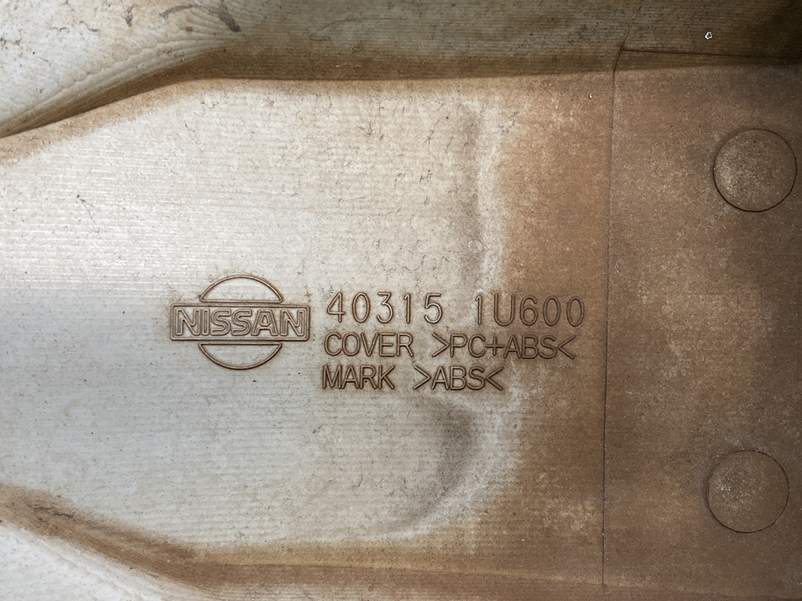 B438_4 NISSAN NOTE E11 Genuine 14inch WHEEL CAP / HUB CAP x1 40315 1U600 x1 » NZ.95 » JDM-PARTS NZ » JDM-PARTS NZ Nissan logo and part numbers embossed on a brown automotive component: 40315 1U600, PC+ABS, ABS marks visible. NISSAN NOTE E11 Genuine 14inch WHEEL CAP / HUB CAP x1 40315 1U600 x1 » JDM-PARTS NZ