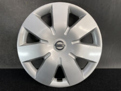 Silver Nissan wheel hubcap with eight angular spokes and central Nissan emblem.
