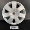 Silver Nissan wheel cover with eight spokes and a central Nissan badge, shown on a dark surface. NISSAN NOTE E11 Genuine 14inch WHEEL CAP / HUB CAP x1 40315 1U600 x1 » JDM-PARTS NZ