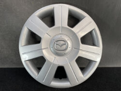Silver Mazda hubcap with eight spokes and Mazda emblem at center, designed for a car wheel replacement