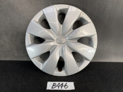 Silver Toyota hubcap with a multi-spoke design and centered Toyota emblem on a dark surface.