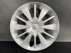 Silver Toyota hubcap with a 12-spoke angular design and the Toyota emblem in the center