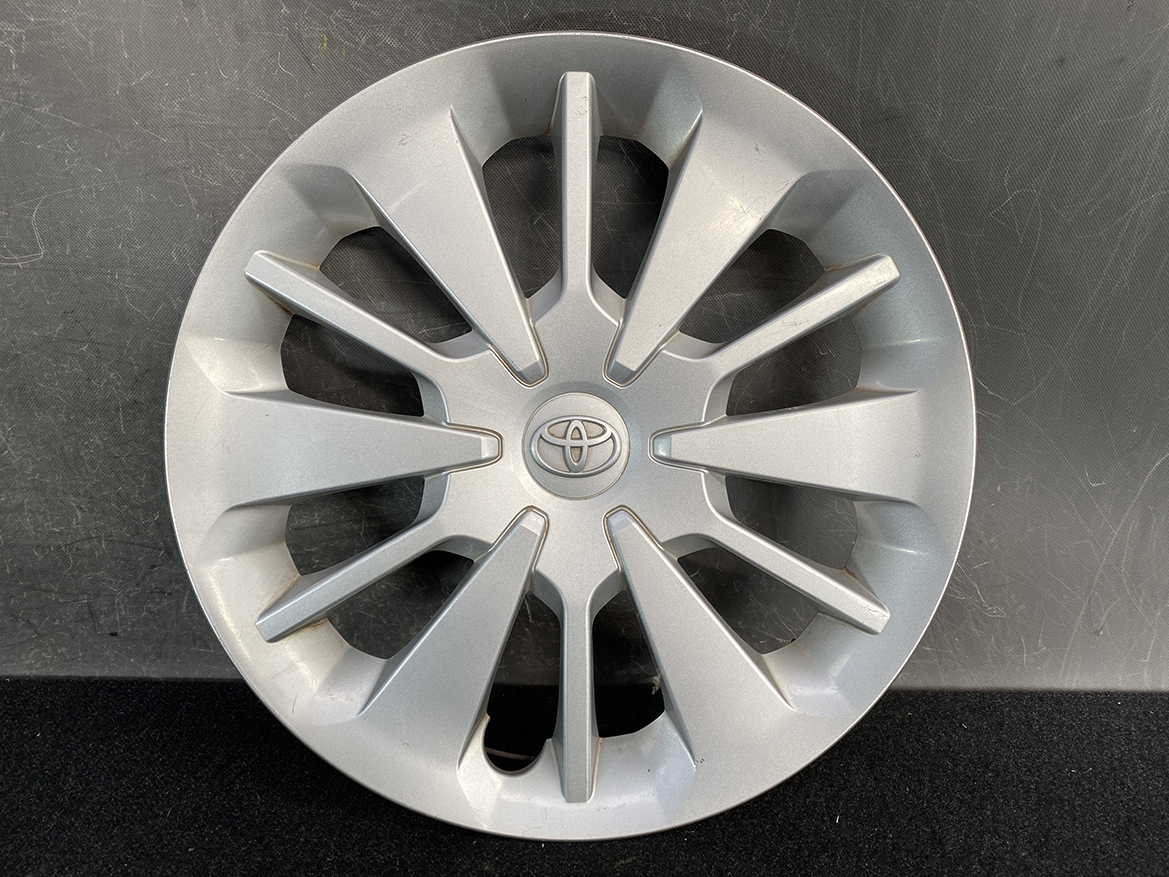 B448_2 TOYOTA PASSO M700A Genuine 14inch WHEEL CAP / HUB CAP x1 » NZ.95 » JDM-PARTS NZ » JDM-PARTS NZ Silver Toyota hubcap with a 12-spoke angular design and the Toyota emblem in the center TOYOTA PASSO M700A Genuine 14inch WHEEL CAP / HUB CAP x1 » JDM-PARTS NZ