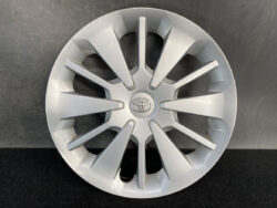 Silver Toyota alloy wheel cover with multiple angular spokes and a central Toyota emblem.