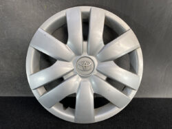 Silver Toyota hubcap with an eight-spoke design and Toyota emblem in the center.