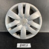 Silver Toyota hubcap with an eight-spoke star design, showing light scratches, resting on a dark surface with a small handwritten tag labeled B453 TOYOTA BELTA SCP92 NCP96 KSP92 Genuine 14inch WHEEL CAP / HUB CAP x1 » JDM-PARTS NZ