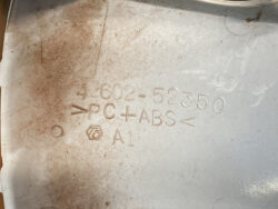 Plastic molded part with markings: part number 4602-52350, material PC+ABS, A1 grade, and a small circular logo mark nearby.