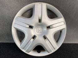 Silver Honda wheel hubcap with a five-spoke design and central Honda emblem at the center.