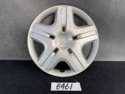 Silver Honda hubcap with five-spoke design and visible scratches on the surface.