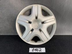 Honda hubcap (wheel cover) in silver with five spokes and a central Honda logo, showing surface scratches and scuffs.