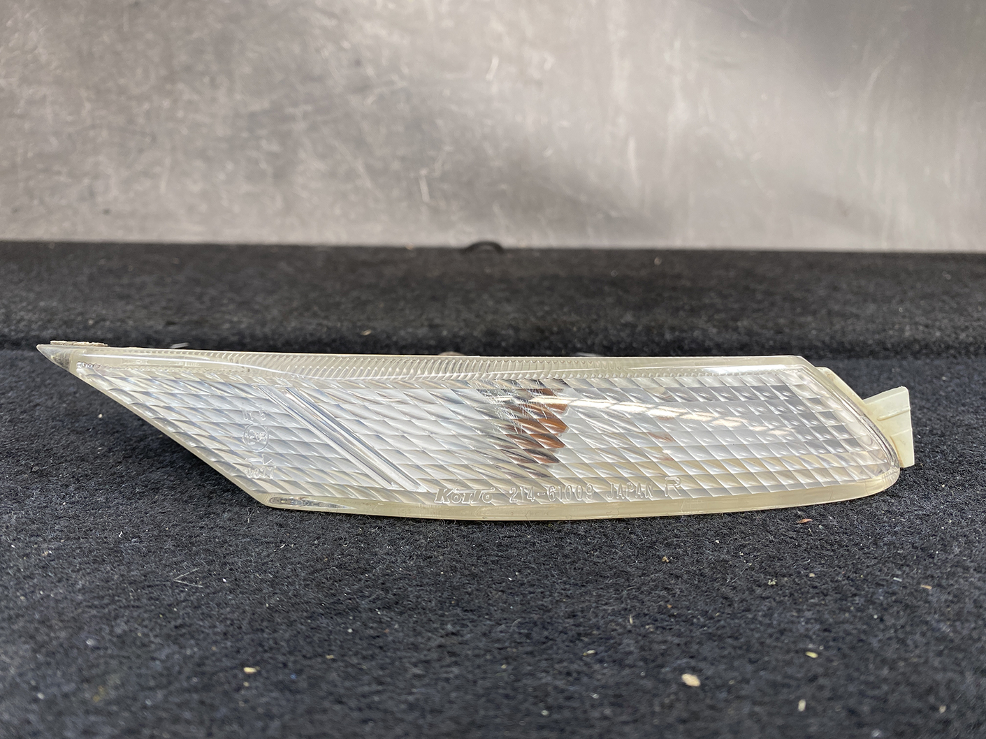 B463_4 MAZDA RX-8 SE3P Genuine Side Indicator KOITO 214-61009 Right Side x1 » NZ.95 » JDM-PARTS NZ » JDM-PARTS NZ Translucent car side marker/turn-signal lens with a diamond-cut pattern, placed on a dark surface MAZDA RX-8 SE3P Genuine Side Indicator KOITO 214-61009 Right Side x1 » JDM-PARTS NZ