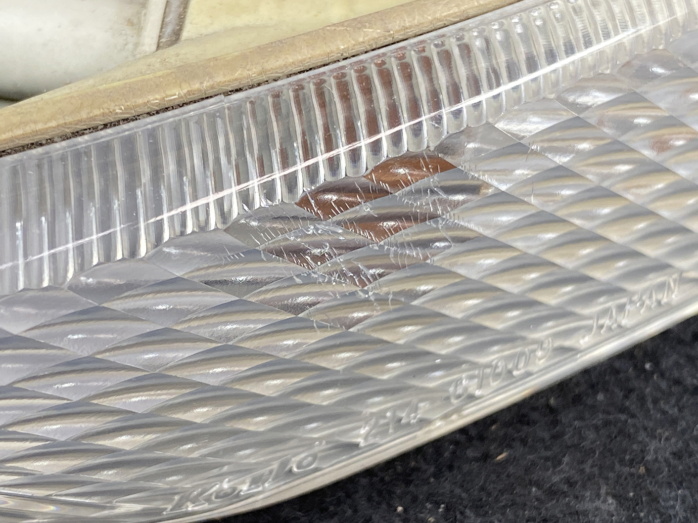 B463_6 MAZDA RX-8 SE3P Genuine Side Indicator KOITO 214-61009 Right Side x1 » NZ.95 » JDM-PARTS NZ » JDM-PARTS NZ Close-up of a clear, diamond-pattern lens on a vehicle light with scratches and slight damage along the edge MAZDA RX-8 SE3P Genuine Side Indicator KOITO 214-61009 Right Side x1 » JDM-PARTS NZ