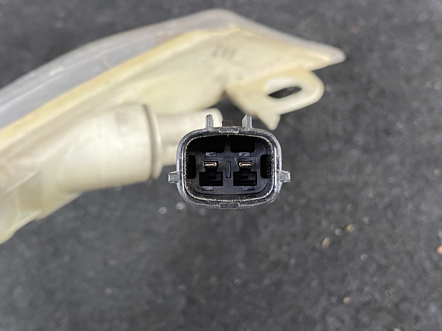 B464_5 MAZDA RX-8 SE3P Genuine Side Indicator KOITO 214-61009 Left Side x1 » NZ.95 » JDM-PARTS NZ » JDM-PARTS NZ Close-up of an oval two-pin automotive electrical connector seen from the front with side latch tabs still visible. MAZDA RX-8 SE3P Genuine Side Indicator KOITO 214-61009 Left Side x1 » JDM-PARTS NZ