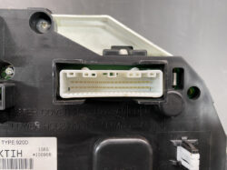 White plastic multi-pin connector port on a black electronic device housing (close-up)