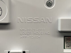 Close-up of a gray Nissan automotive part with embossed text: NISSAN, NM-0021-001, LOWER HOUSING, >PP-TD40