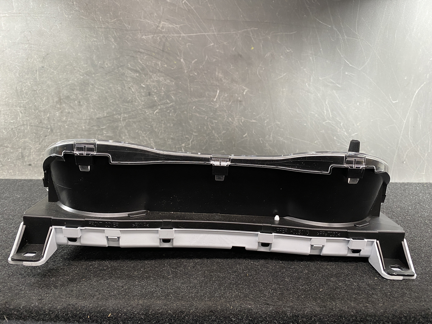 B466_7 NISSAN ROOX B44A Genuine Instrument Cluster 24810 7NB0D » NZ1.95 » JDM-PARTS NZ » JDM-PARTS NZ Automotive instrument cluster housing with a clear plastic cover and mounting brackets on a black base. NISSAN ROOX B44A Genuine Instrument Cluster 24810 7NB0D » JDM-PARTS NZ