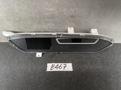 Car instrument cluster with two rectangular black screens and chrome trim mounted on a plastic housing.