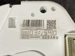 Label on a white automotive part showing a barcode, QR code, and the text 'SUBARU' with serial numbers and a 16-digit code beneath it.