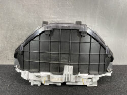 Rear view of a black curved automotive dashboard/air diffuser housing with a grid pattern and light gray mounting frame at the base.