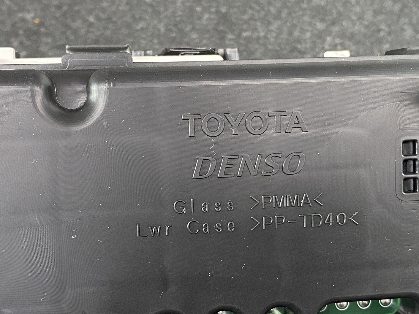 B473_4 TOYOTA PRIUS C AQUA NHP10 Genuine Instrument Cluster 83800-5CU90 » NZ1.95 » JDM-PARTS NZ » JDM-PARTS NZ Back of a black plastic Toyota Denso module case with molded text reading Glass PMMA and Lwr Case PP-TD40 TOYOTA PRIUS C AQUA NHP10 Genuine Instrument Cluster 83800-5CU90 » JDM-PARTS NZ