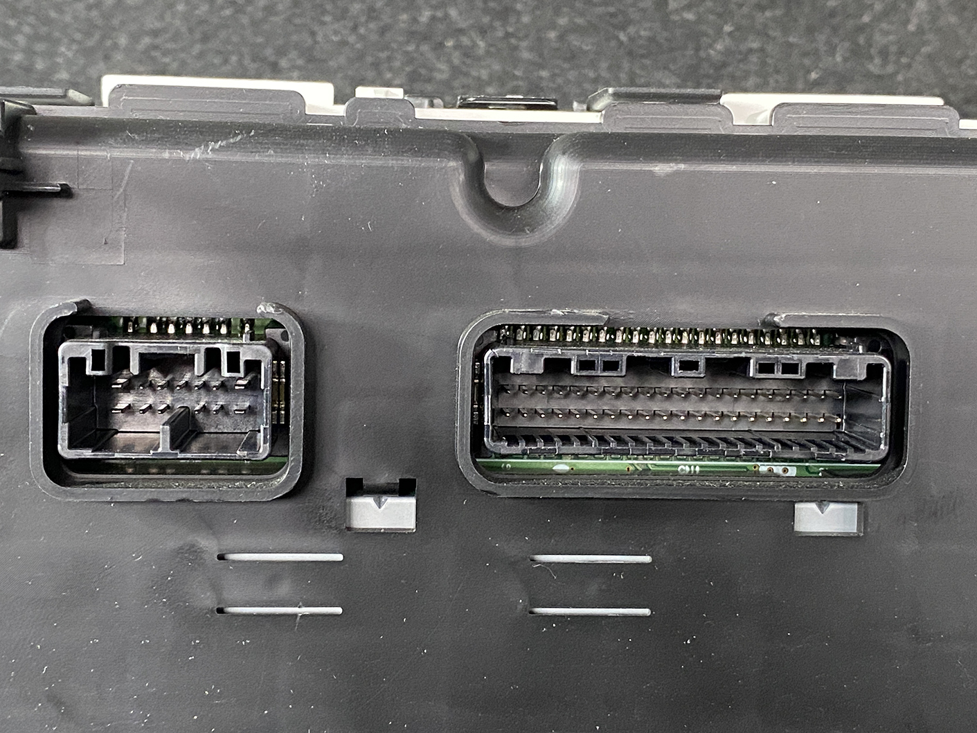 B473_5 TOYOTA PRIUS C AQUA NHP10 Genuine Instrument Cluster 83800-5CU90 » NZ1.95 » JDM-PARTS NZ » JDM-PARTS NZ Two modular electrical connectors on a black panel: a small rectangular plug on the left and a larger multi-pin socket on the right. TOYOTA PRIUS C AQUA NHP10 Genuine Instrument Cluster 83800-5CU90 » JDM-PARTS NZ