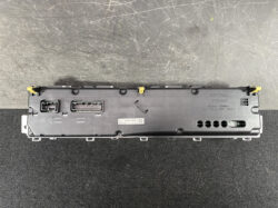 Rear view of a Toyota instrument cluster module with multiple connectors and mounting tabs.