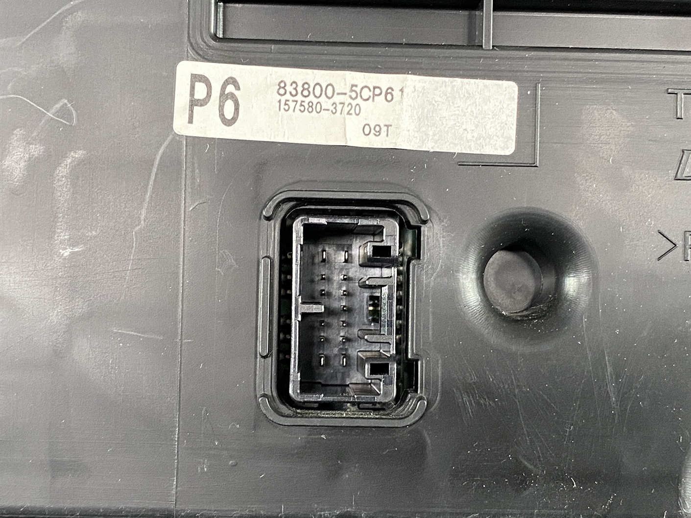 B474_5 TOYOTA SIENTA NHP170 Genuine Instrument Cluster 83800-5CP61 » NZ1.95 » JDM-PARTS NZ » JDM-PARTS NZ Close-up of a vehicle’s electronic control unit connector port with a rectangular multi-pin socket and a labeled P6 sticker above (83800-5CP6 157580-3720). TOYOTA SIENTA NHP170 Genuine Instrument Cluster 83800-5CP61 » JDM-PARTS NZ
