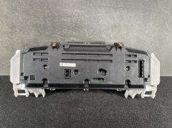 Rear view of a Toyota instrument cluster module with connectors, orange clips, and mounting brackets