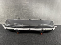 Automotive instrument cluster housing with a clear protective lens and mounting clips